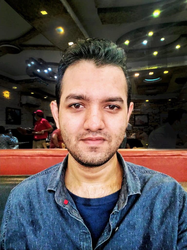 Color portrait of a linguist wearing a blue denim shirt